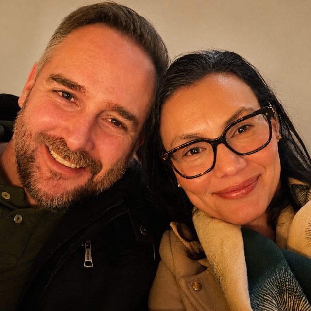Lynn, smiling beside her partner